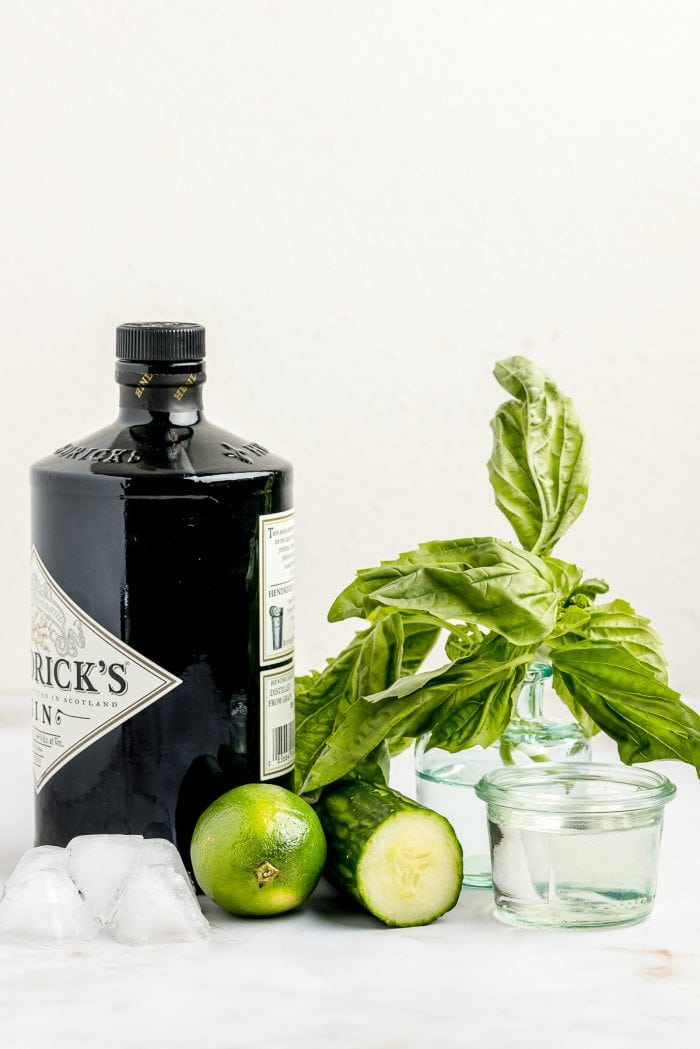 The ingredients needed to make a cucumber Basil gimlet. 