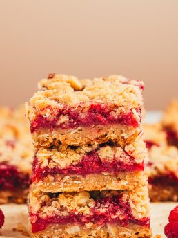 A stack of three raspberry crumble bars.