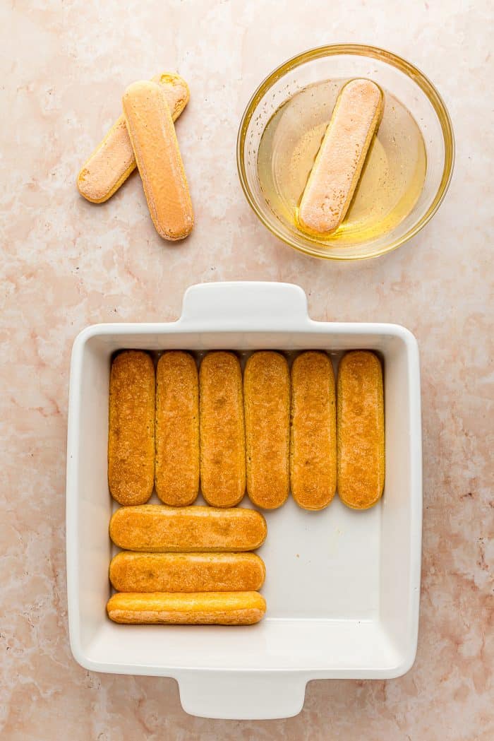 A white baking tray with lady fingers.