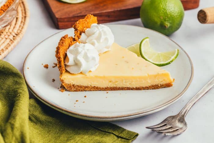 A plate with a slice of key lime pie and a fork.