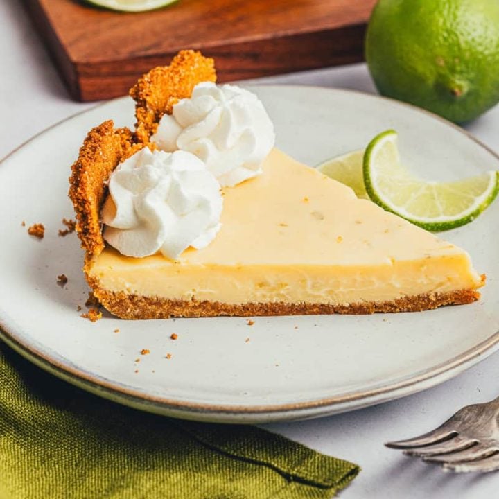 A plate with a slice of key lime pie and a fork.