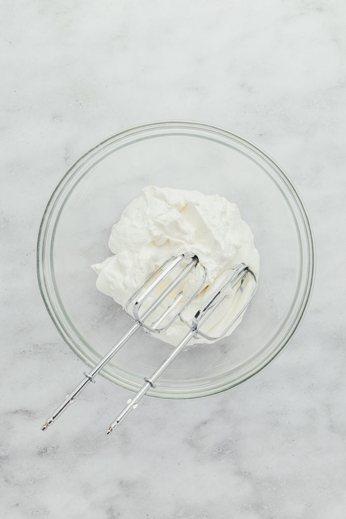 A glass bowl with whipped cream.