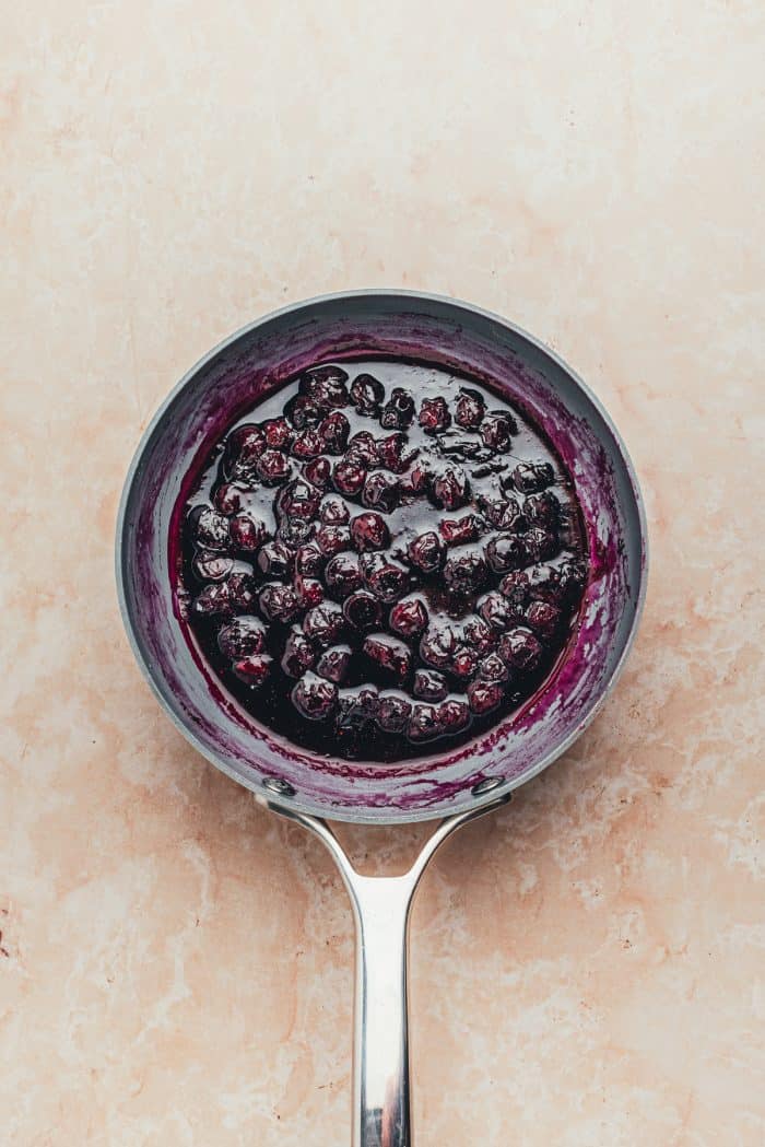 The cooked blueberry compote in a saucepan.