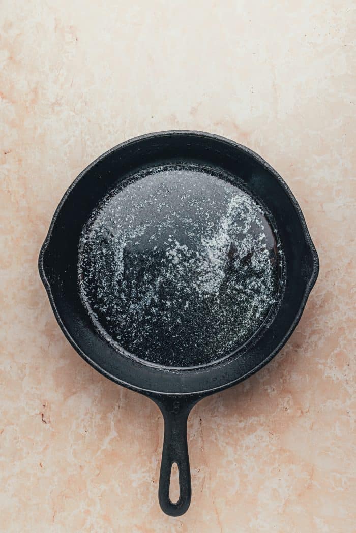 A hot skillet with melted butter.