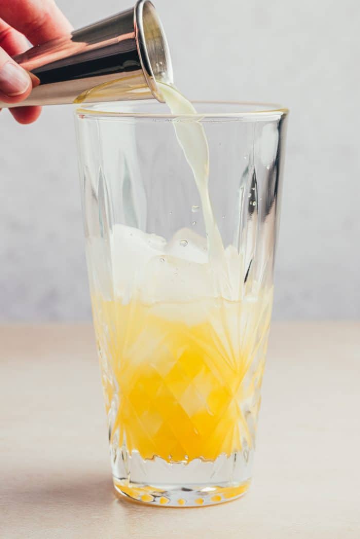 A glass filled with orange juice.