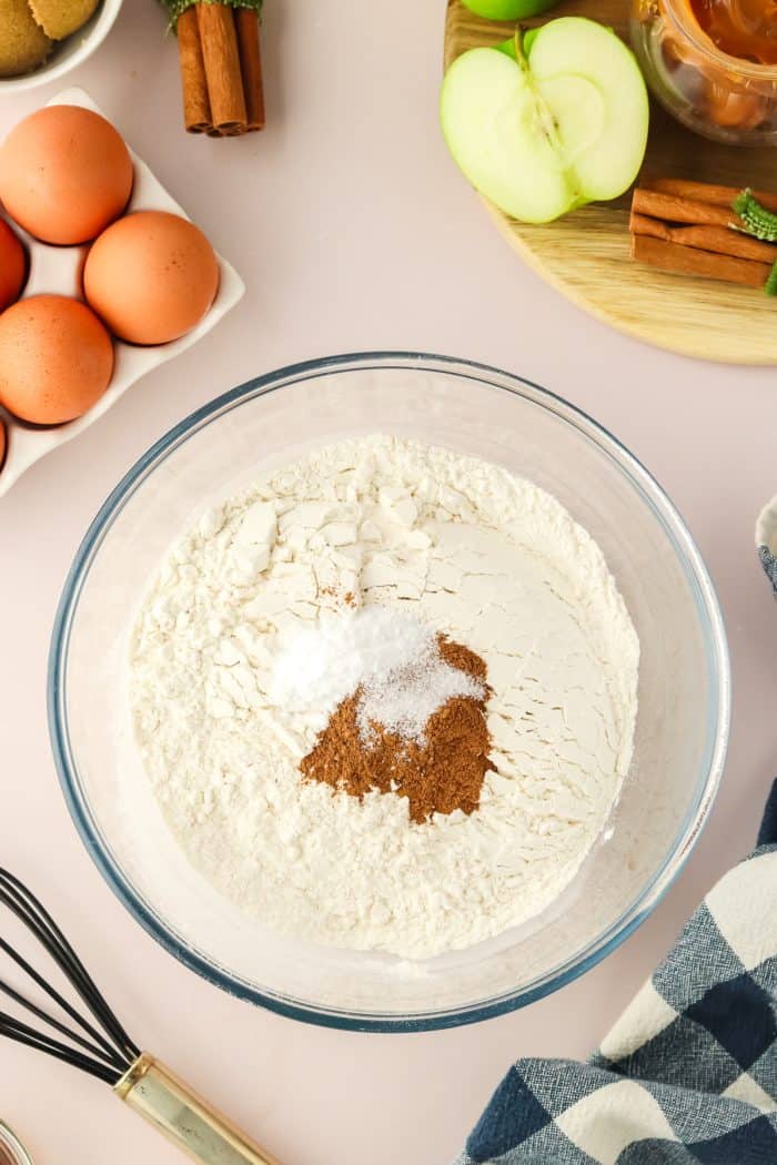 Flour mixed with cinnamon in a glass mixing bowl.