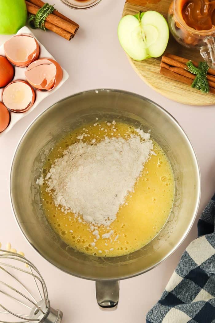 The ingredients for cake batter in a metal bowl.