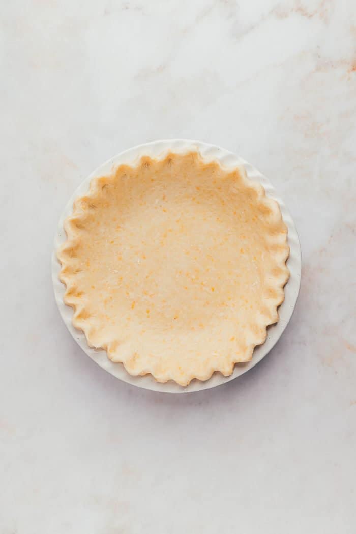 A pie plate with a unbaked pie crust.