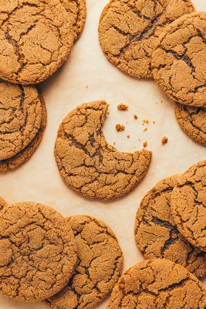 A pile of molasses cookies with a bite out of them.