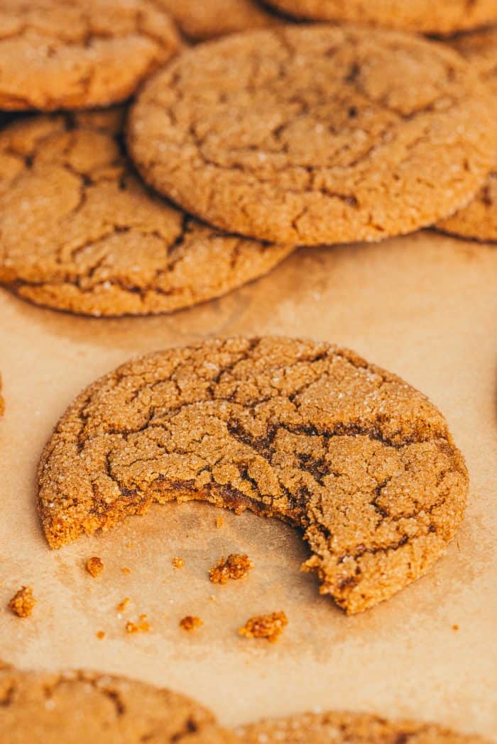 A pile of molasses cookies with a bite out of them.