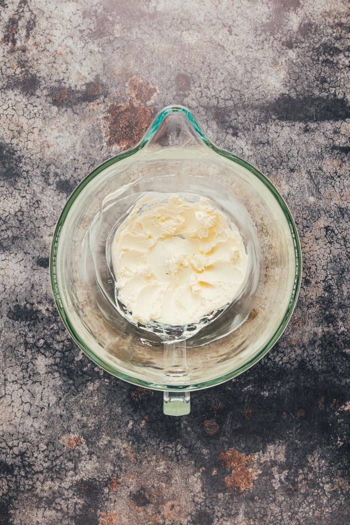 Creamed butter in a glass mixing bowl.