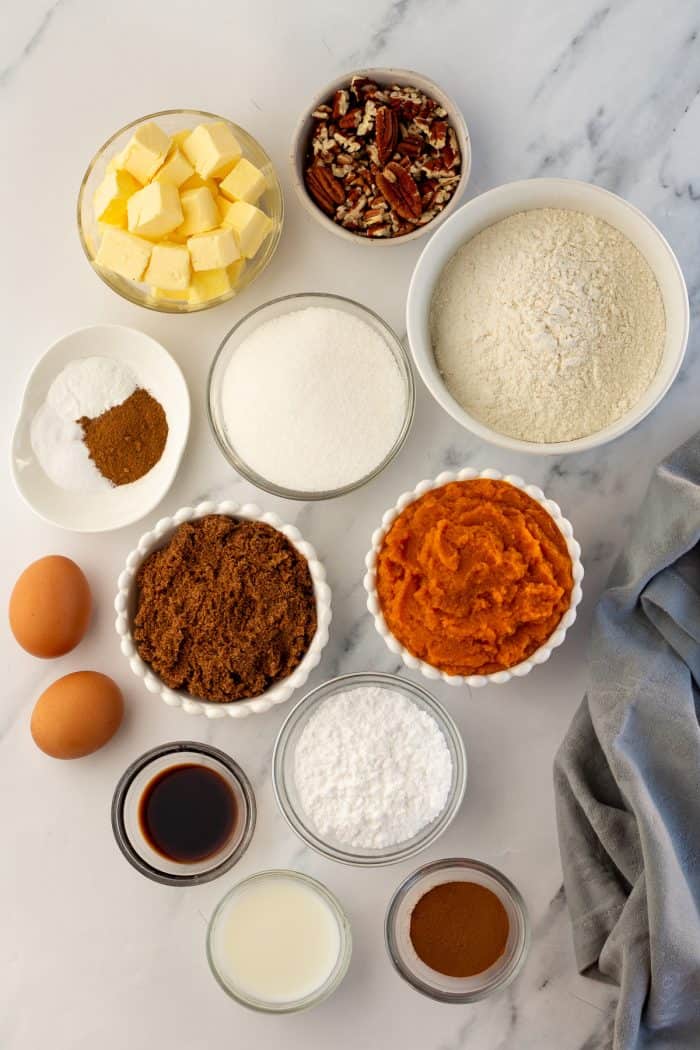 Various bowls that are filled with ingredients for pumpkin coffee cake.