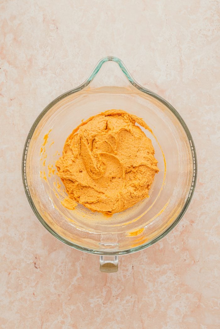 A glass bowl with raw cookie batter.