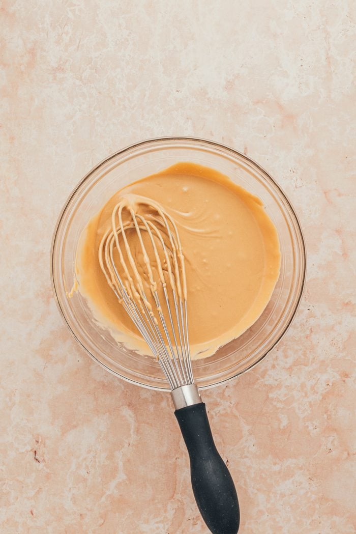 A glass bowl with the latte icing mixed together.