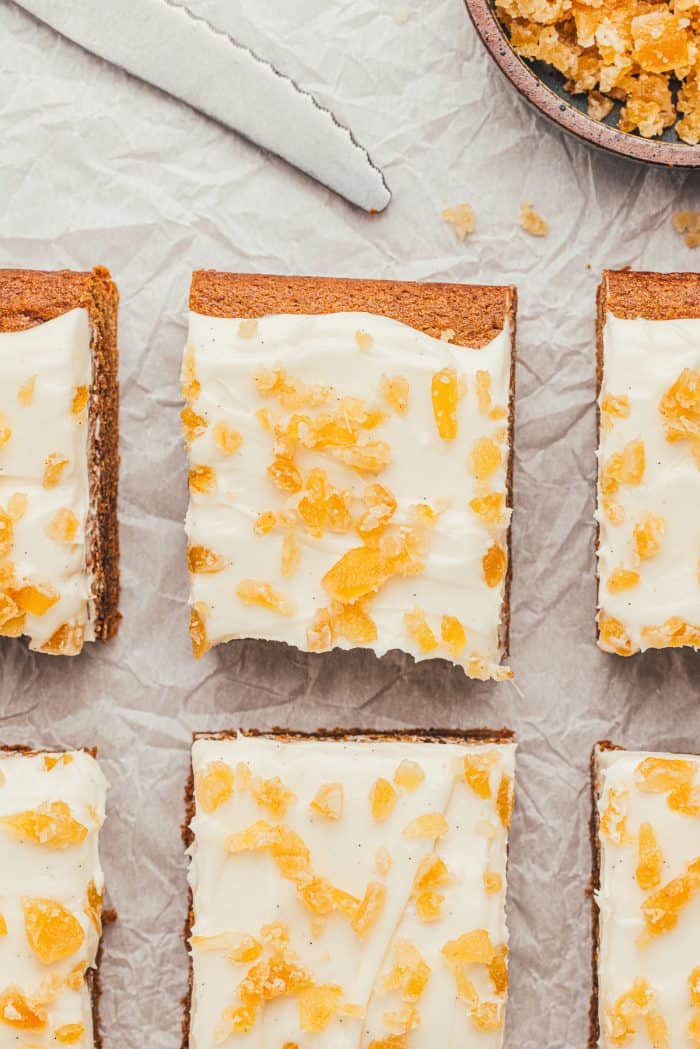 The gingerbread bars with frosting and candied ginger cut into squares.