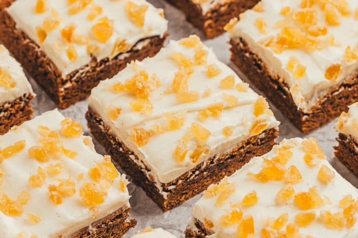 The gingerbread bars with frosting and candied ginger cut into squares.