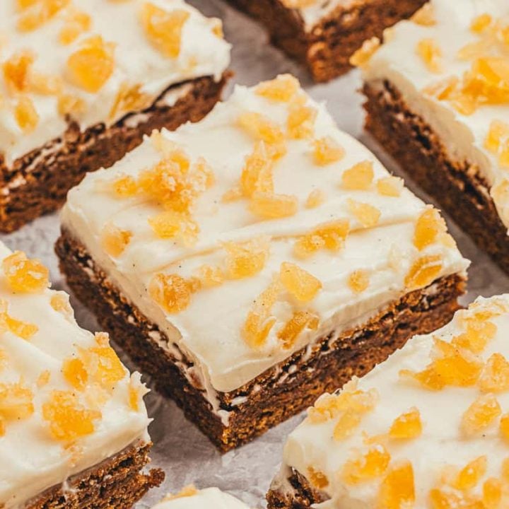 The gingerbread bars with frosting and candied ginger cut into squares.