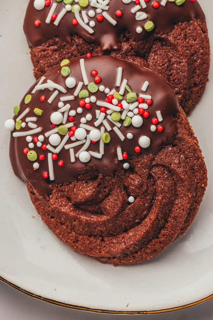 A white plate with two chocolate orange butter cookies.