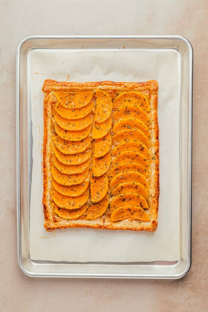 A baked butternut squash on a baking sheet.