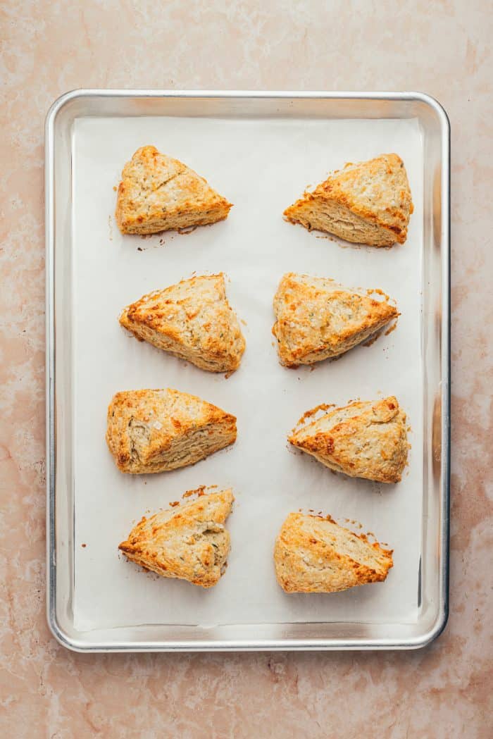 Baked scones on a parchment-lined baking sheet.