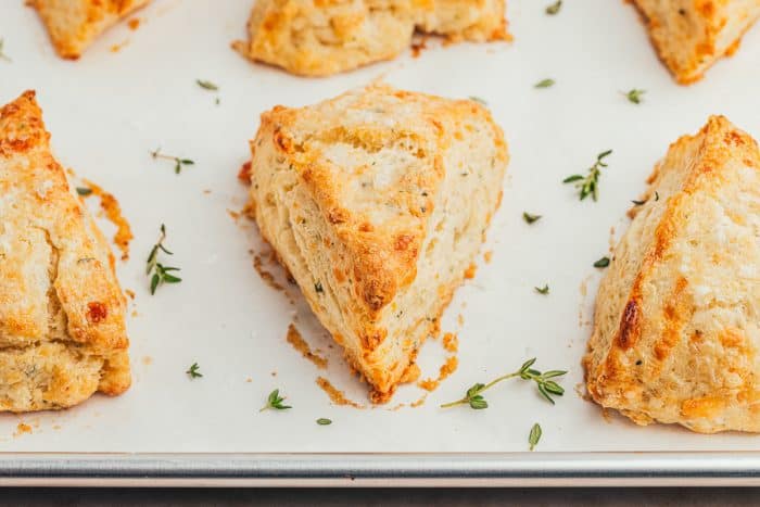 Gruyère and Thyme Scones on a baking sheet with parchment paper.