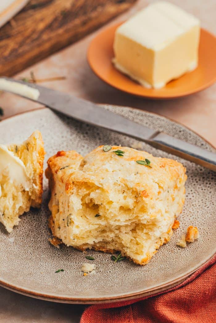 A plate with a scone sliced in half.