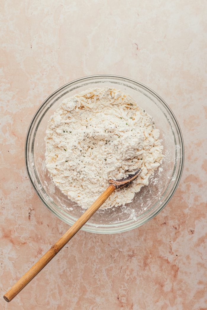 A glass bowl with the dough for the gruyere scones.