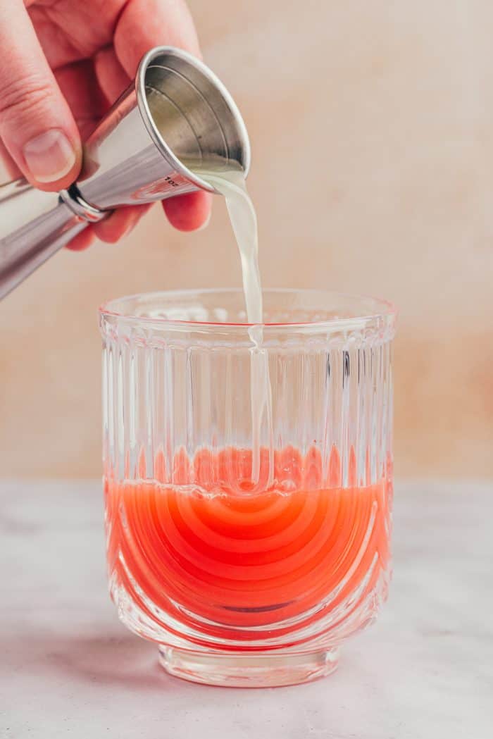 Lime juice being added to the blood orange juice.