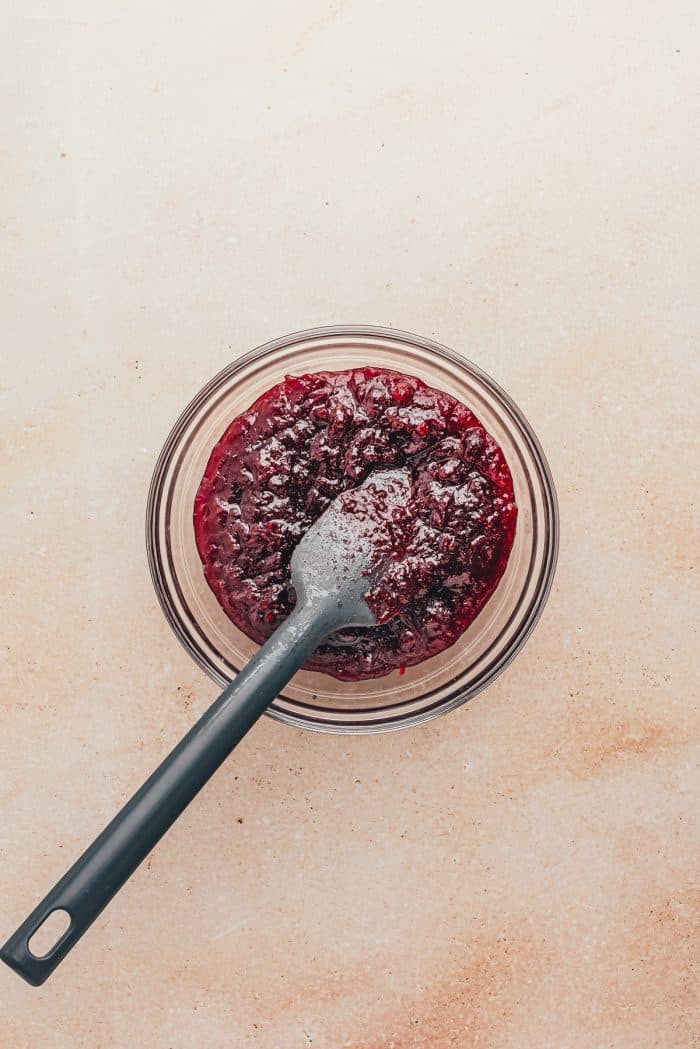 A glass bowl with homemade cranberry jam.