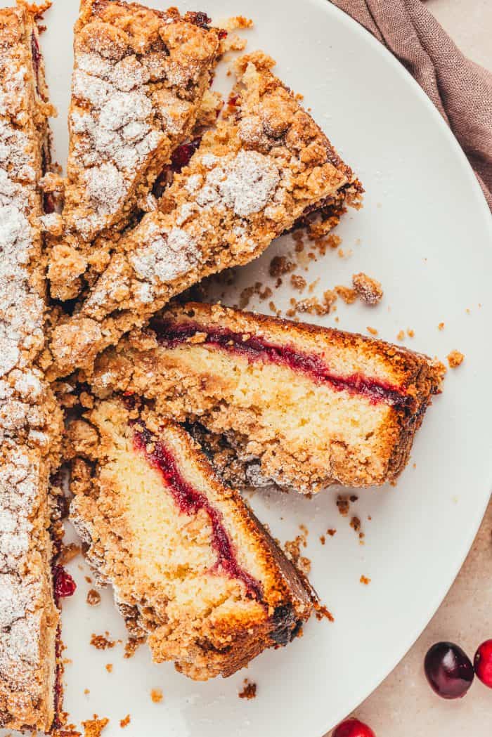 A large plate with slices of coffee cake showing the jam center.