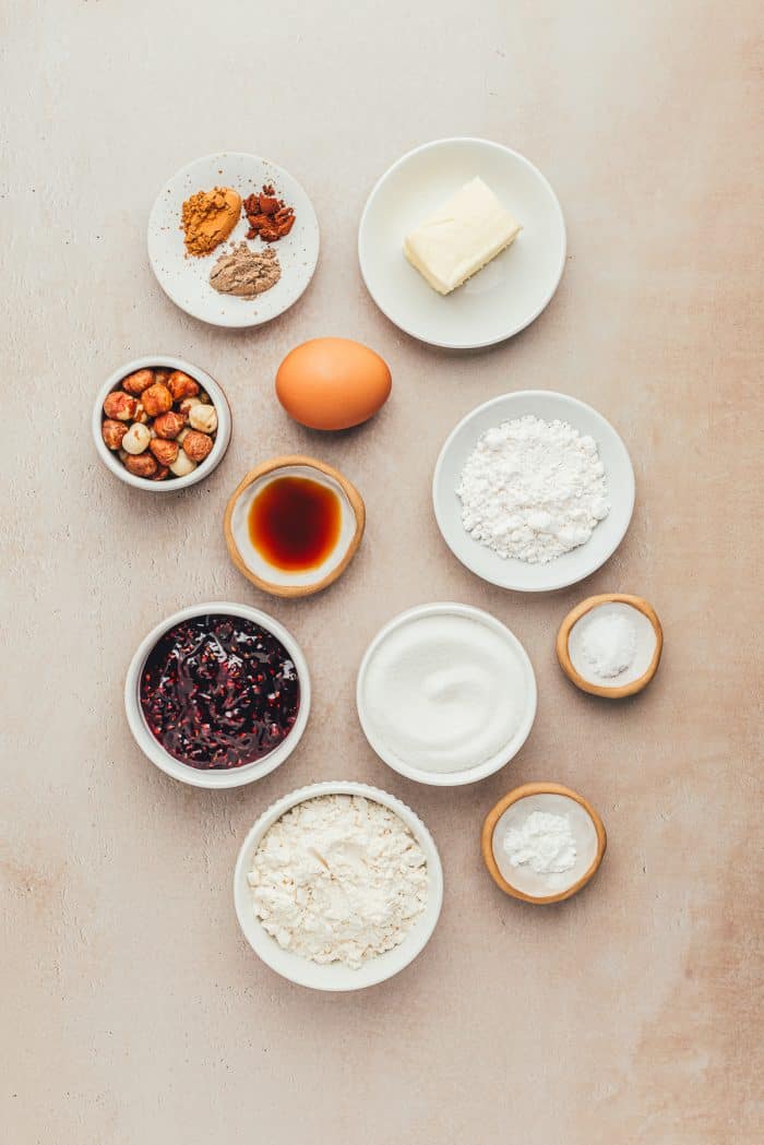 Various bowls with the ingredients for hazelnut Linzer Cookies.