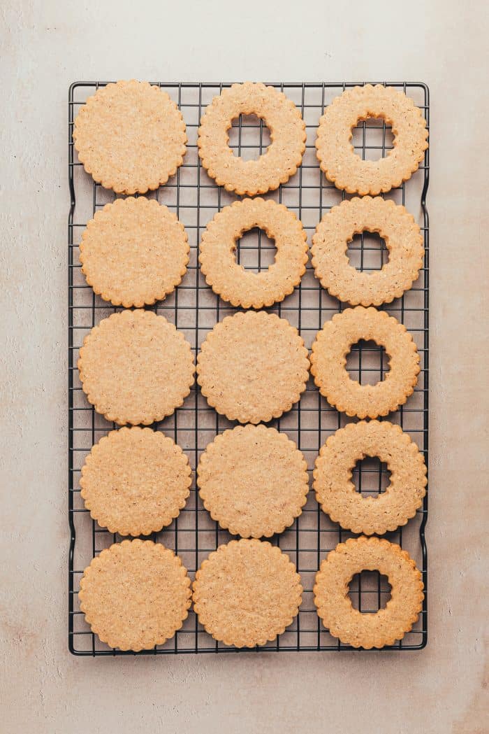 Baked Linzer cookies on a cooling rack.