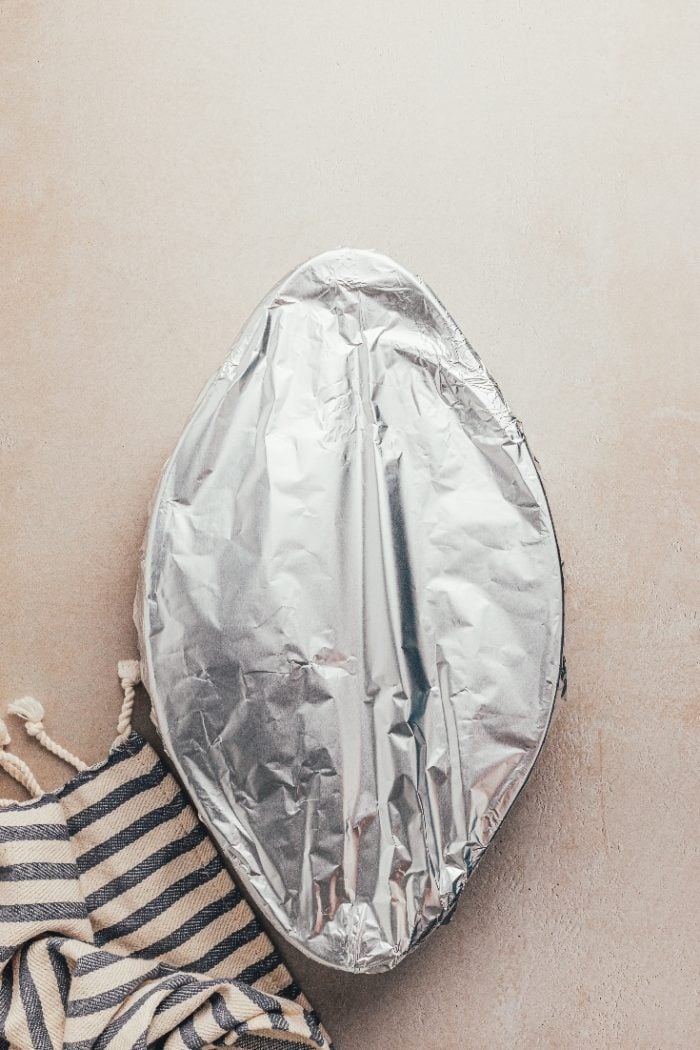 A baking dish covered with aluminium foil.