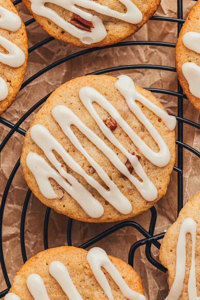 An up close image of glazed spice drop cookies on a cooling rack.