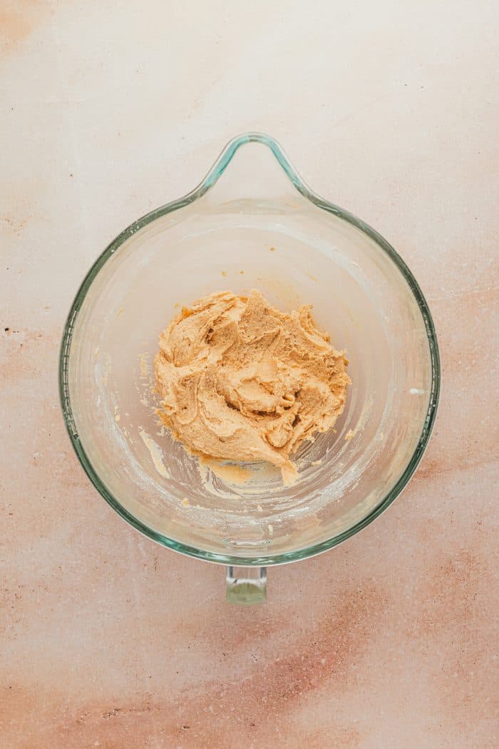 Raw cookie batter in a glass bowl.