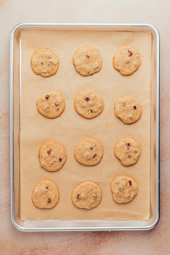 Baked cookies on a cookie sheet with parchment paper.