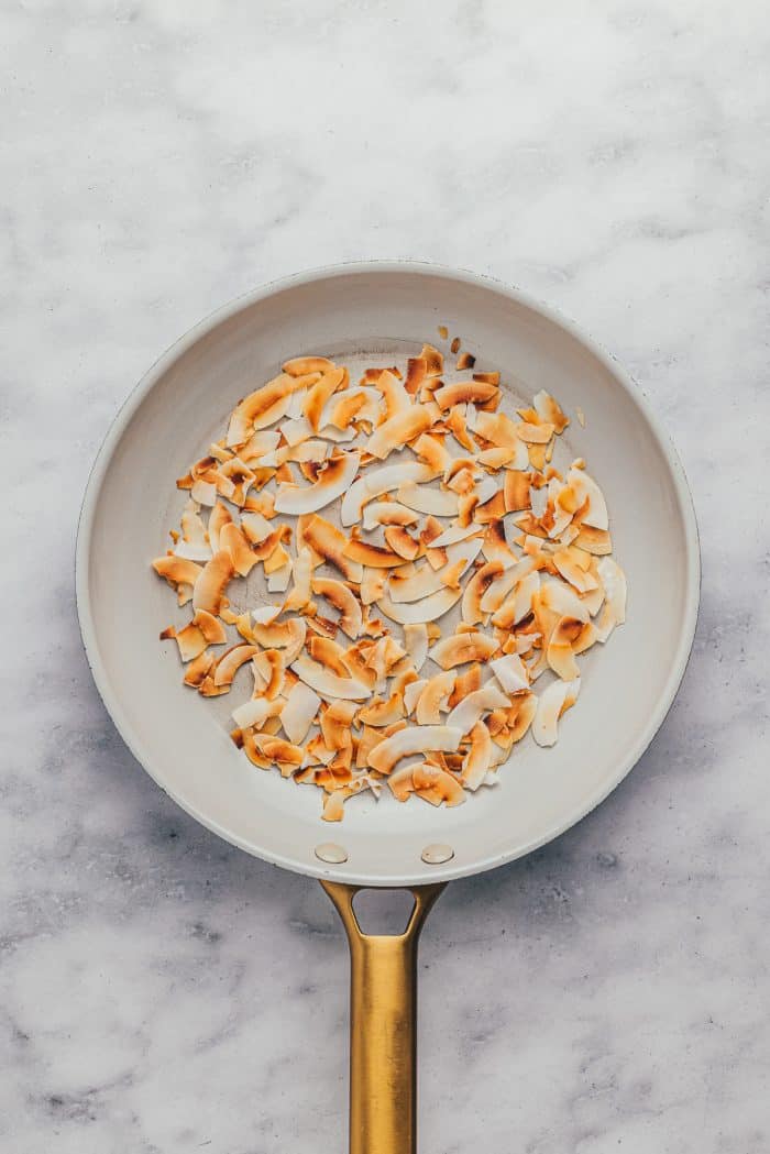 A skillet with toasted coconut flakes.