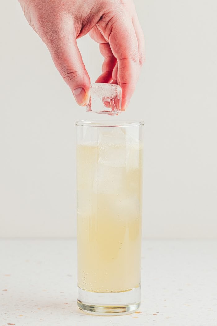 Ice cubes being added to a lemon elderflower mocktail.