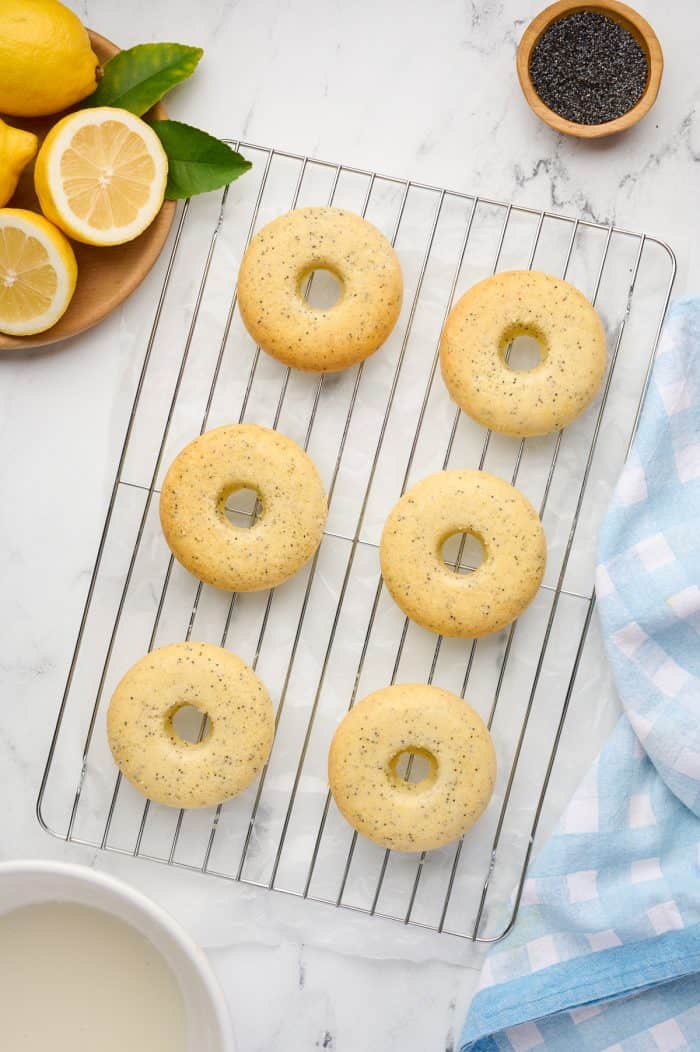 Baked lemon donuts on a cooling rack.