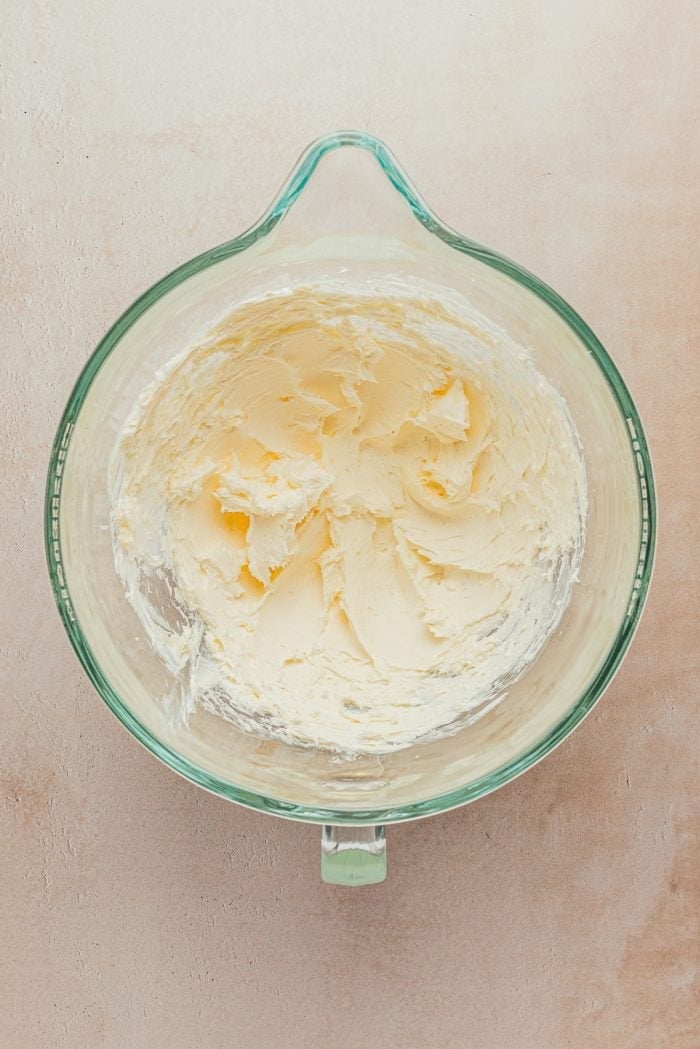 Butter and cream cheese mixed together in a glass bowl.