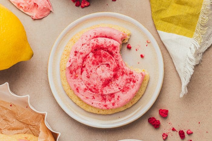 A lemon sugar cookie on a white plate.