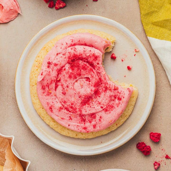 A lemon sugar cookie on a white plate.