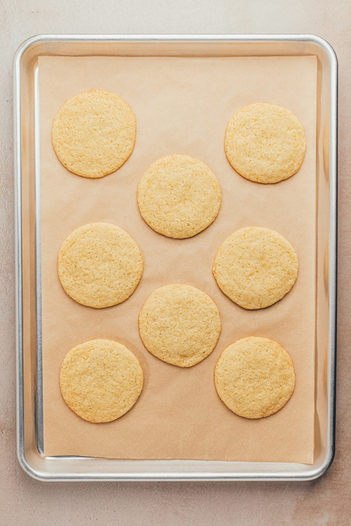 Baked lemon sugar cookies on a cookie tray.