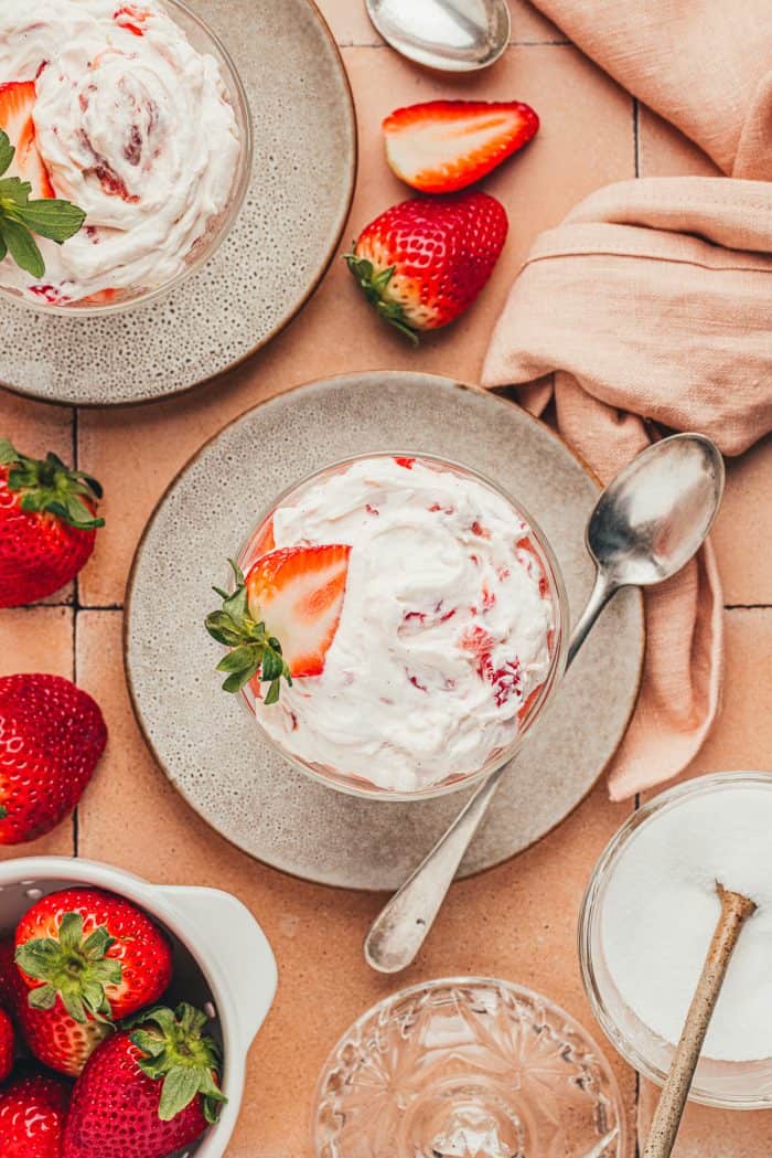 A glass parfait dish with homemade strawberry fool.