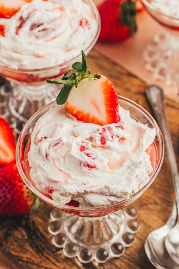 A glass parfait dish with homemade strawberry fool.