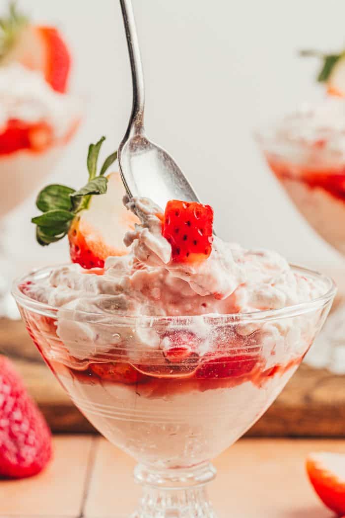 A glass parfait dish with homemade strawberry fool.