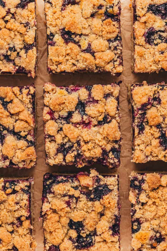 Nine slices of blueberry crumb cake.