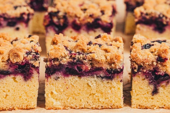 Six slices of blueberry crumb cake.