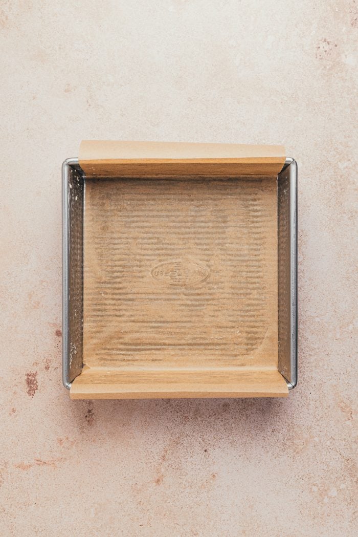 A greased baking pan with parchment paper.