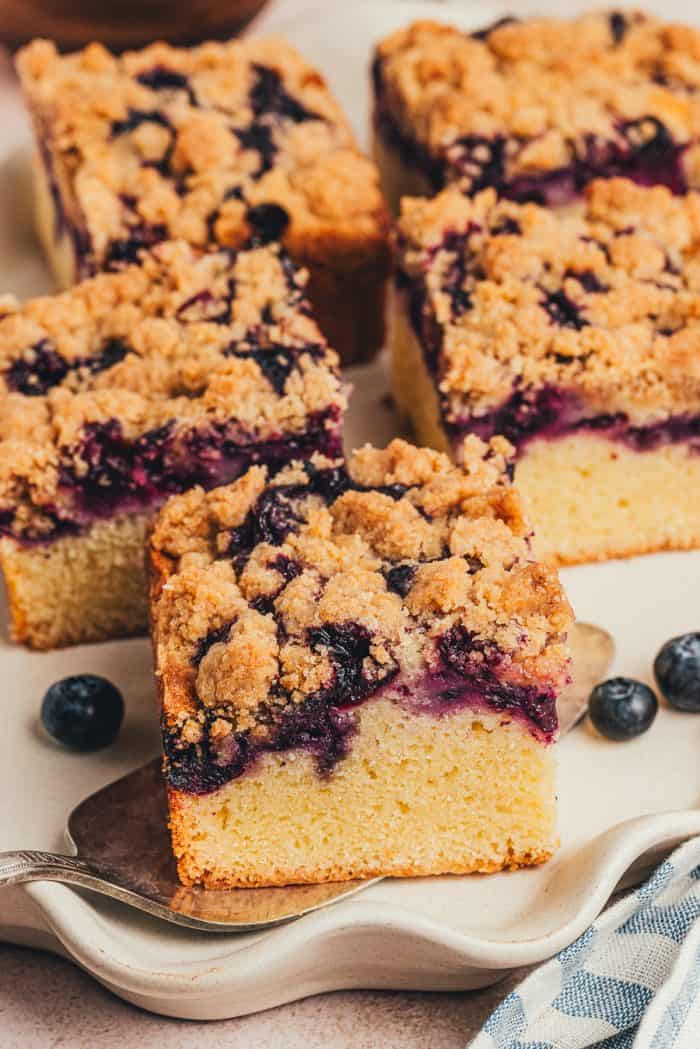 Five slices of blueberry crumb cake on a platter.